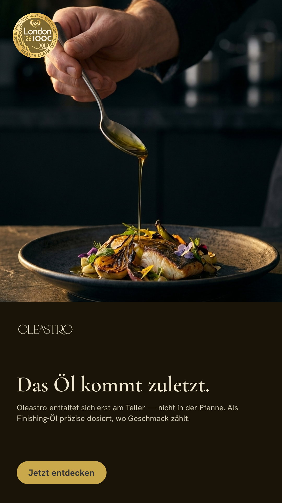 Oleastro olive oil poured as a finishing drizzle over a dish, warm still-life styling.